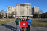 (L-R) Jason Jackson, Carrie Hertz, and Peter Yen pose with the IU Flag on the campus of IU partner Tsinghua University in Beijing. December 8, 2017. Photograph by Jon Kay.
