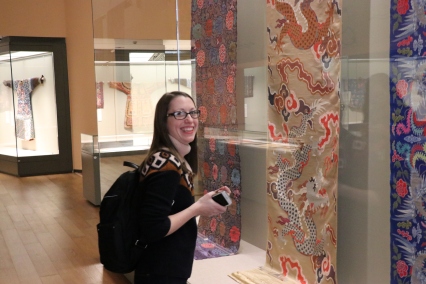 Carrie Hertz enjoys the textile portion of the "Tsinghua Treasures: Exhibition of Tsinghua University Art Museum Collection." December 8, 2017. Photograph by Jon Kay.