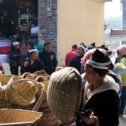 Customers shop for baskets on market day in Lihu town at the stall of Li Guozhong. December 16, 2017. Photograph by Jon Kay.